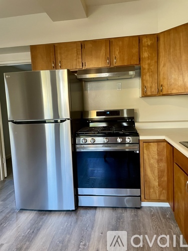 A kitchen with a stainless steel refrigerator and oven.