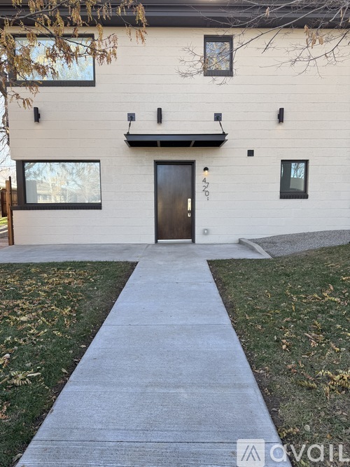 A white house with a black door and windows.