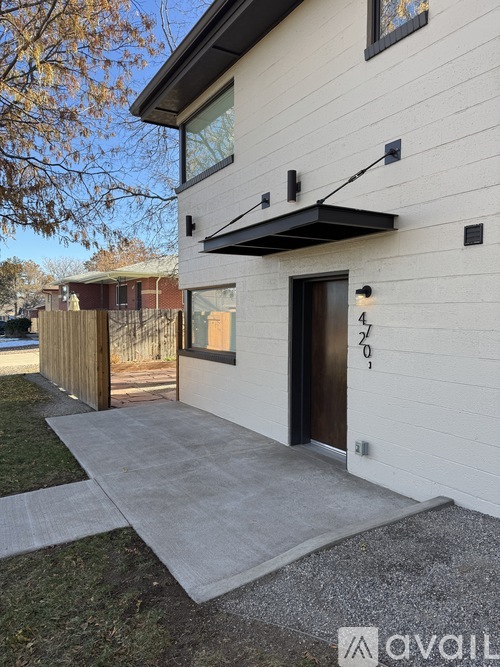 A modern house with a white exterior and a black door.