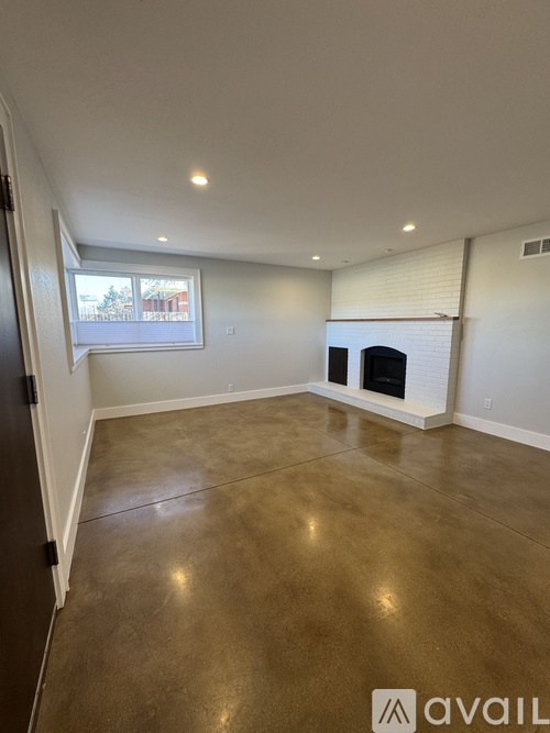 A room with a fireplace and a window.