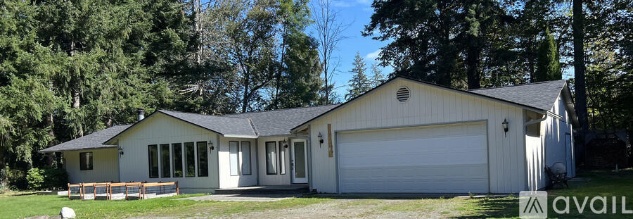 A two-car garage with a white exterior and a covered porch.