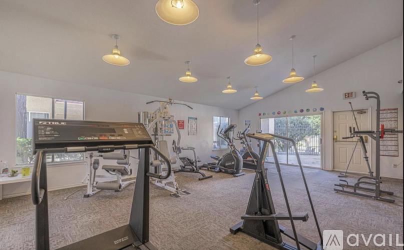 A gym with treadmills, exercise bikes, and other equipment.