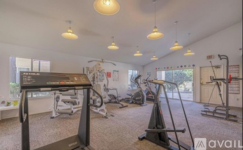 A gym with treadmills, exercise bikes, and other equipment.