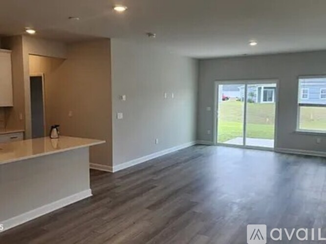 A spacious room with a counter and sliding glass doors.