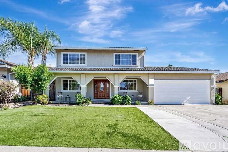 A two-story house with a garage and a front yard.