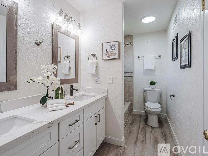 A bathroom with a toilet, sink, and shower.