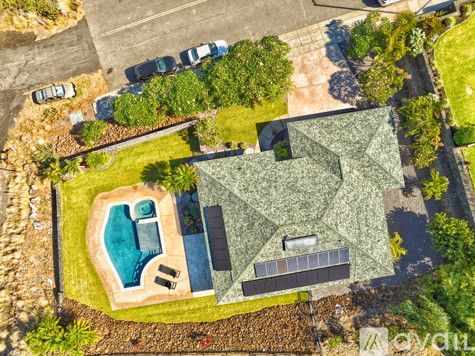 A house with a pool and a green roof.