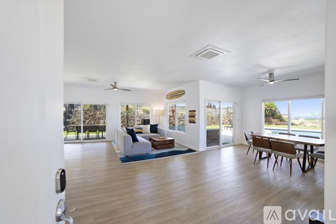 A living room with a white couch and a wooden table.