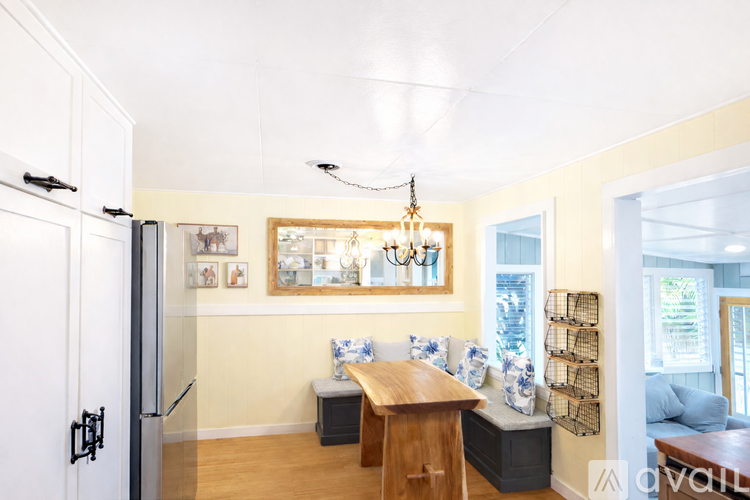 A dining room with a wooden table and chairs.