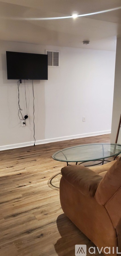 A living room with a couch and a television.