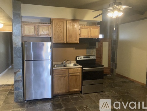 A kitchen with a refrigerator, stove, and oven.