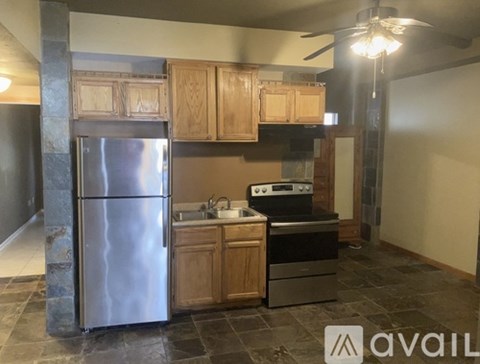 A kitchen with a refrigerator, stove, and oven.