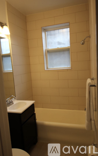 A bathroom with a toilet, sink, and bathtub.