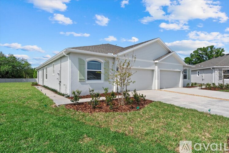 A house with a lawn in front of it is for sale.