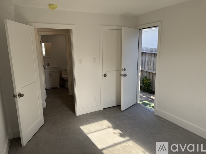 A room with two doors and a window.