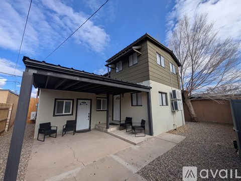 A house with a brown roof and a white door is for sale.