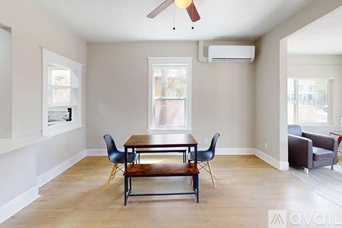A dining room with a table and chairs.