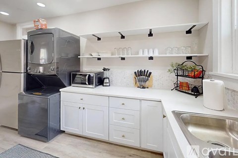 A kitchen with a white fridge and a white counter top.