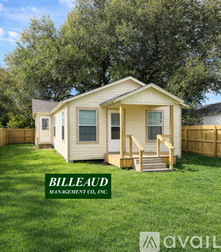 A small house with a deck and a fence is for sale.
