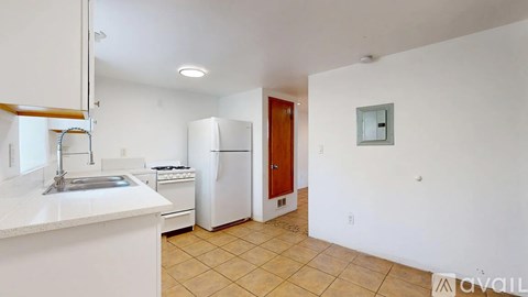 A kitchen with white cabinets and a white counter top.