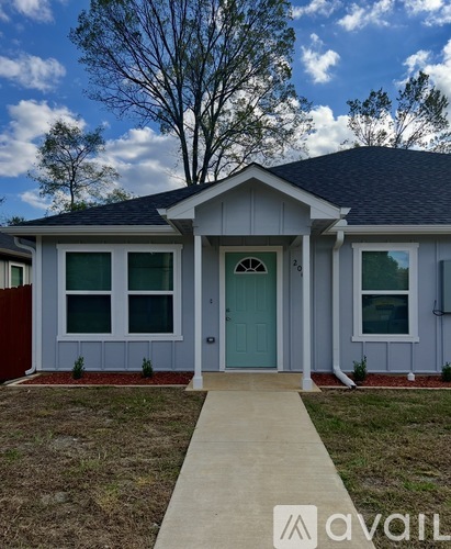 A house with a blue door and a grey roof.