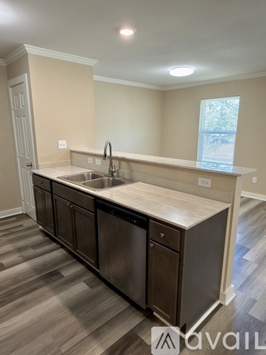 A kitchen with a sink and a window.