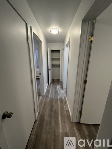 A long hallway with a door on the left and a door on the right.