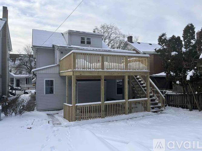 A house with a deck covered in snow.