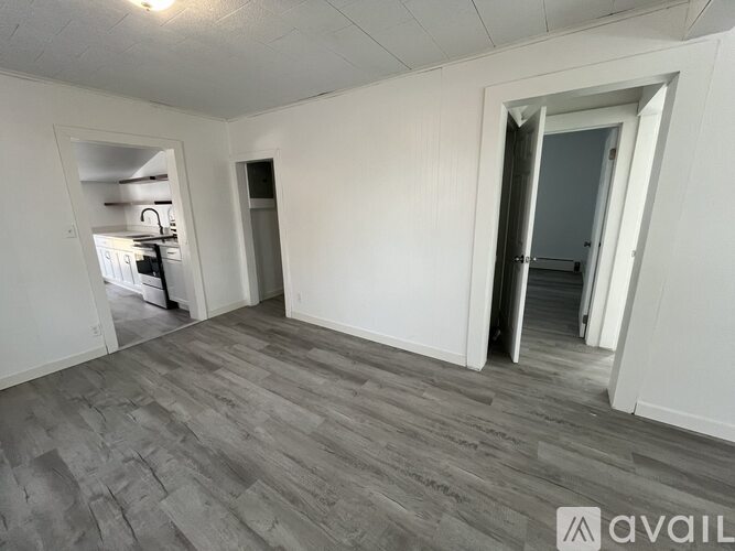 A room with a grey floor and white walls.