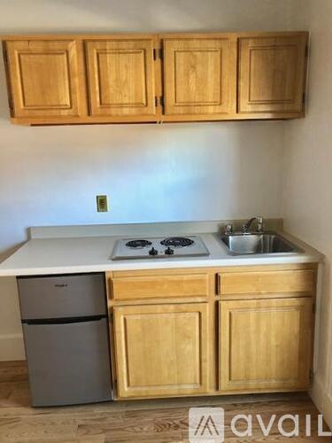 A kitchen with wooden cabinets and a white countertop.