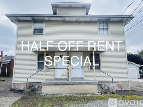 A house with a sign that says "HALF OFF RENT SPECIAL".