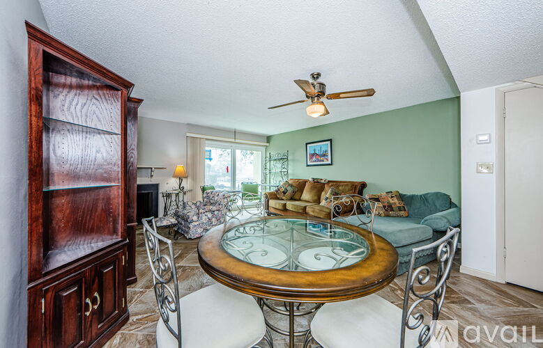 A dining room with a glass table and chairs.