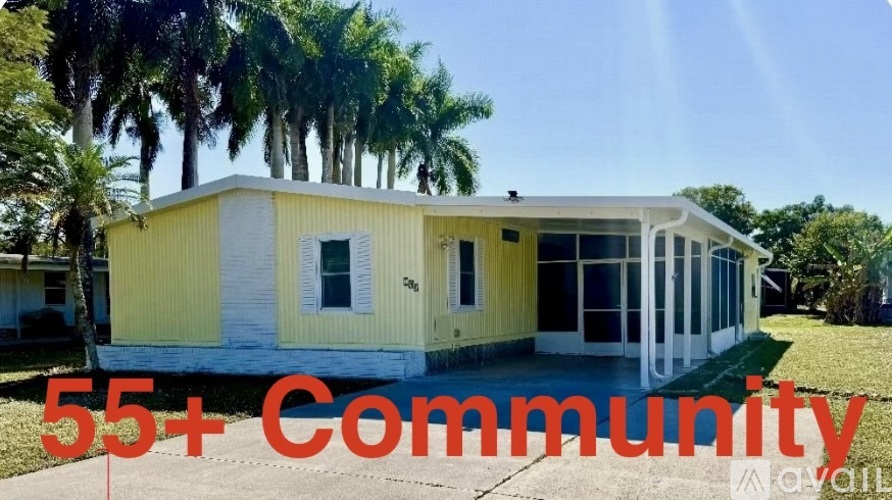 A yellow house with the text "55+ Community" in front of it.