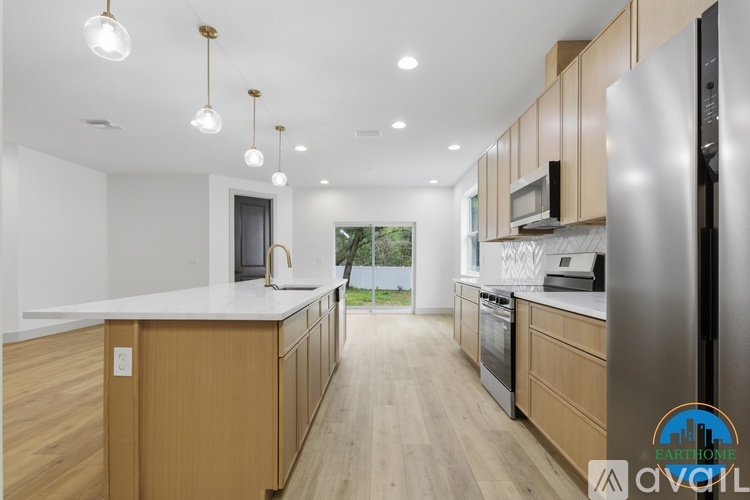 A modern kitchen with wooden cabinets and stainless steel appliances.