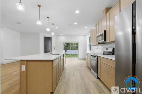 A modern kitchen with wooden cabinets and stainless steel appliances.