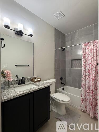 A bathroom with a sink, toilet, and shower.