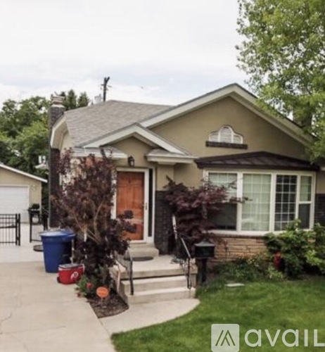 A house with a brown roof and a white garage door.