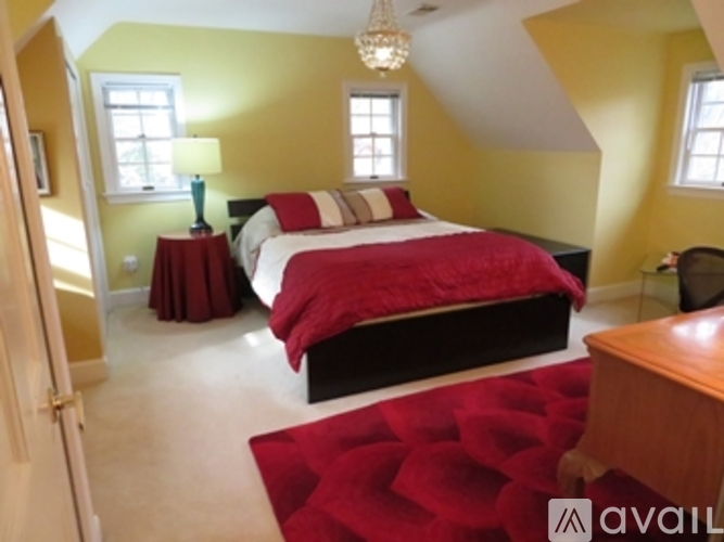 A bedroom with a bed, nightstand, and lamp.