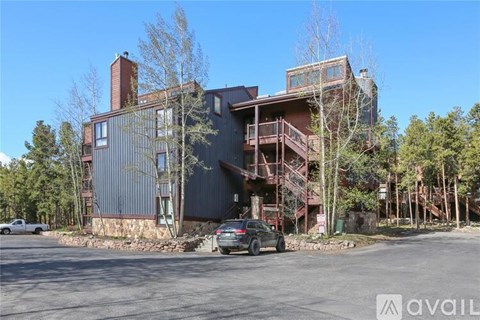 A modern building with a parking lot in front.