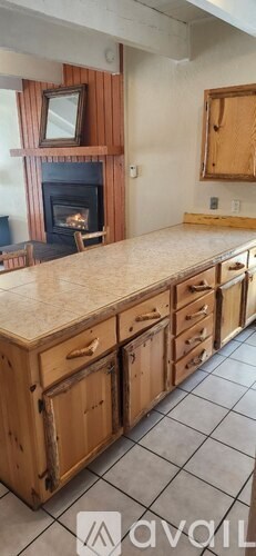A kitchen with wooden cabinets and a stone countertop.