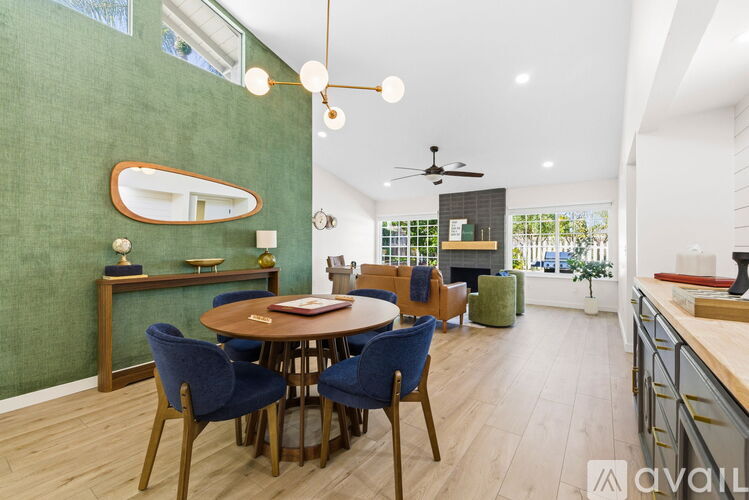 A dining room with a table and chairs.