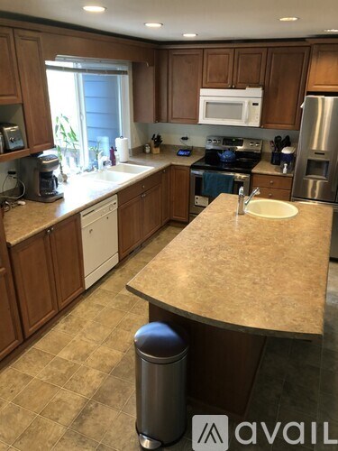 A kitchen with brown cabinets and a beige countertop.