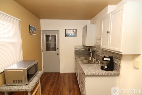A kitchen with a microwave on a countertop.