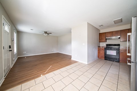 A kitchen with a black oven and white cabinets.