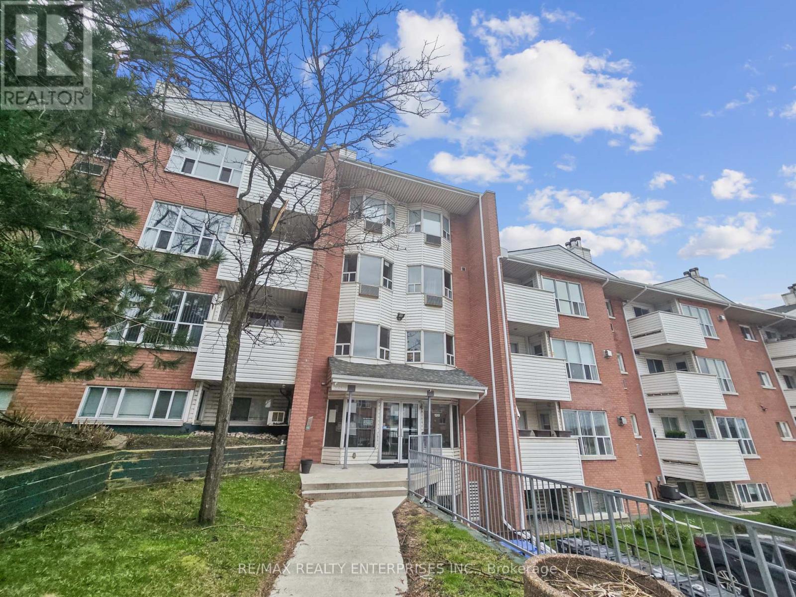 A multi-story apartment building with a clear blue sky above.