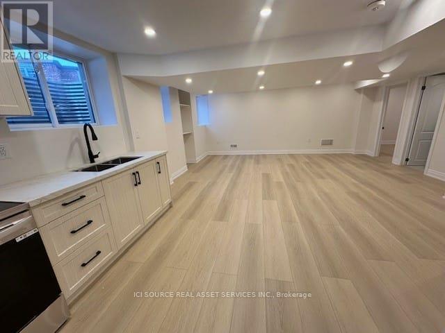 A kitchen with wooden floors and white walls.