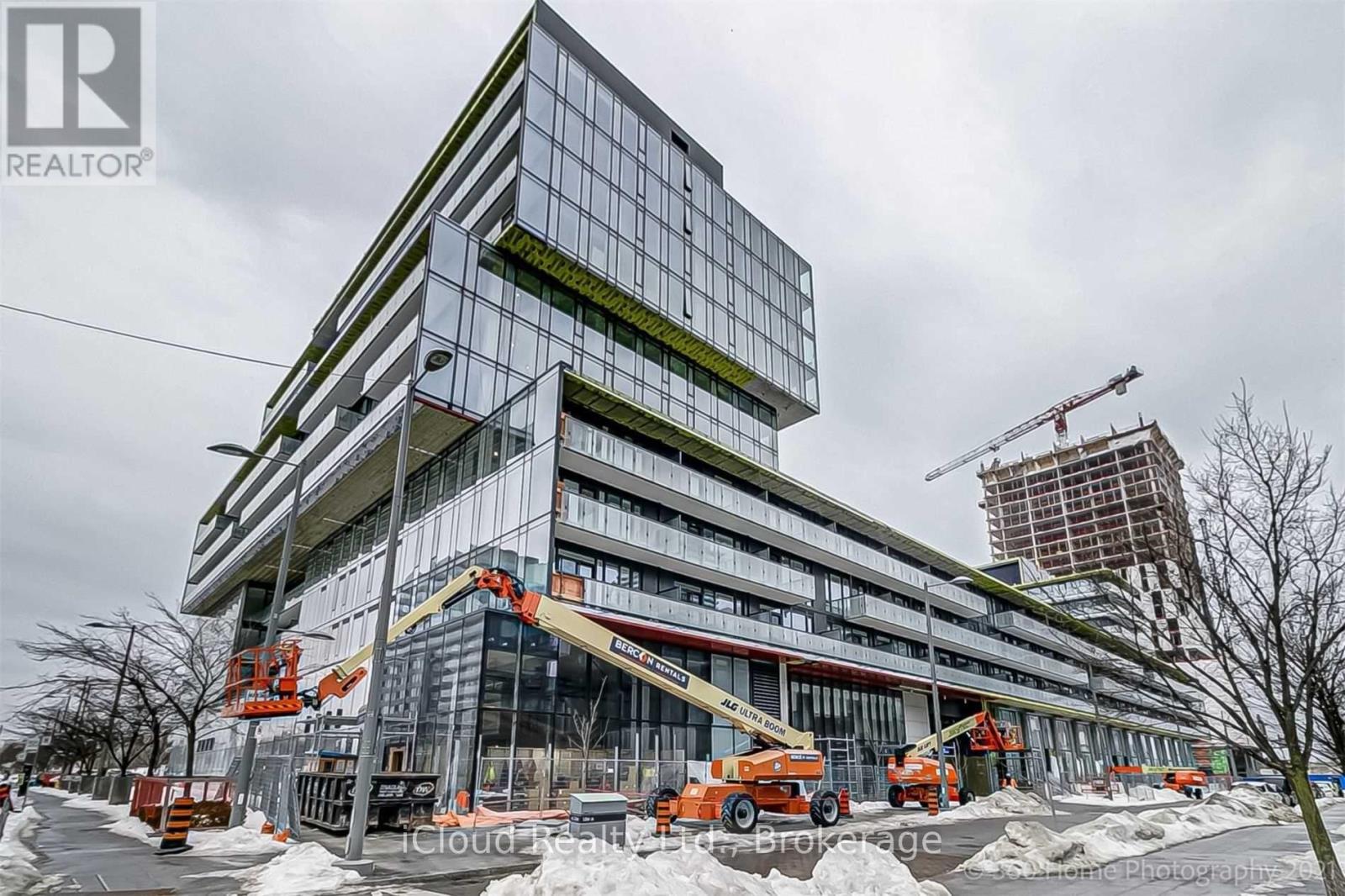 A large building under construction with a crane in the background.