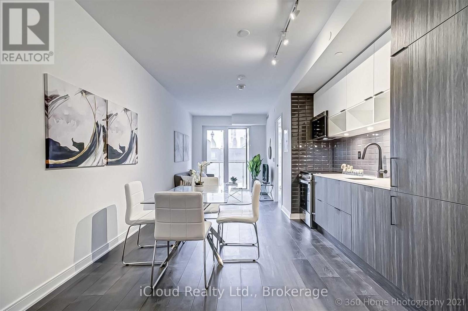 A modern kitchen with a dining table and chairs.