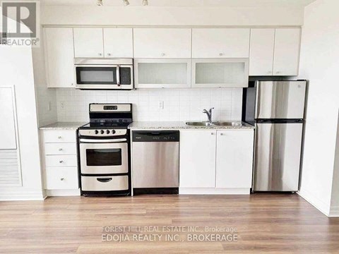 A kitchen with white cabinets and stainless steel appliances.