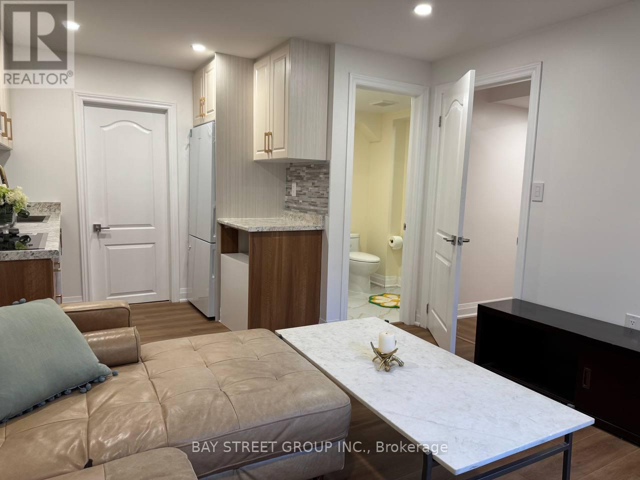 A kitchen with a table and chairs in the middle of the room.
